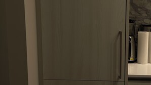 A modern kitchen with a built-in refrigerator and a microwave. - "Chic Retreat: Pet & Smoke-Friendly, Balcony Views, Prime Location!" (Vaughan)