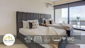 Ein modernes Hotelzimmer mit zwei Doppelbetten, einem Balkon mit Aussicht und Annehmlichkeiten wie Klimaanlage und WLAN.