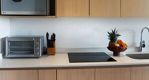 Enjoy cooking in this well-equipped kitchen with a microwave, toaster, and sink.