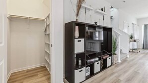 A modern interior with a walk-in closet, built-in shelving, and a staircase leading to another level. - Lakeside Paradise - Pflugerville (Pflugerville)