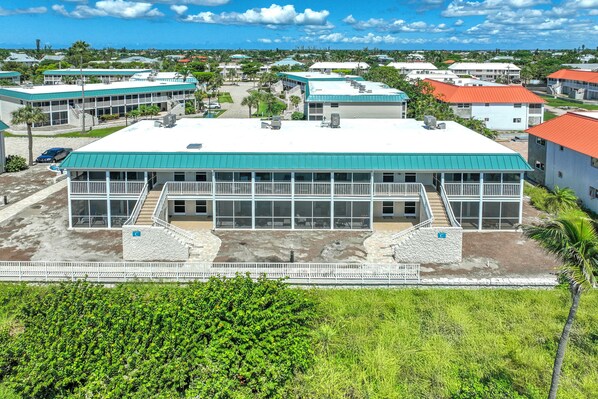 A large building with a flat roof, multiple windows, and a central staircase. - Mesmerizing Unit C7 · Sanibel Arms West | Gulffront Panoramic Gulf Views (Sanibel)