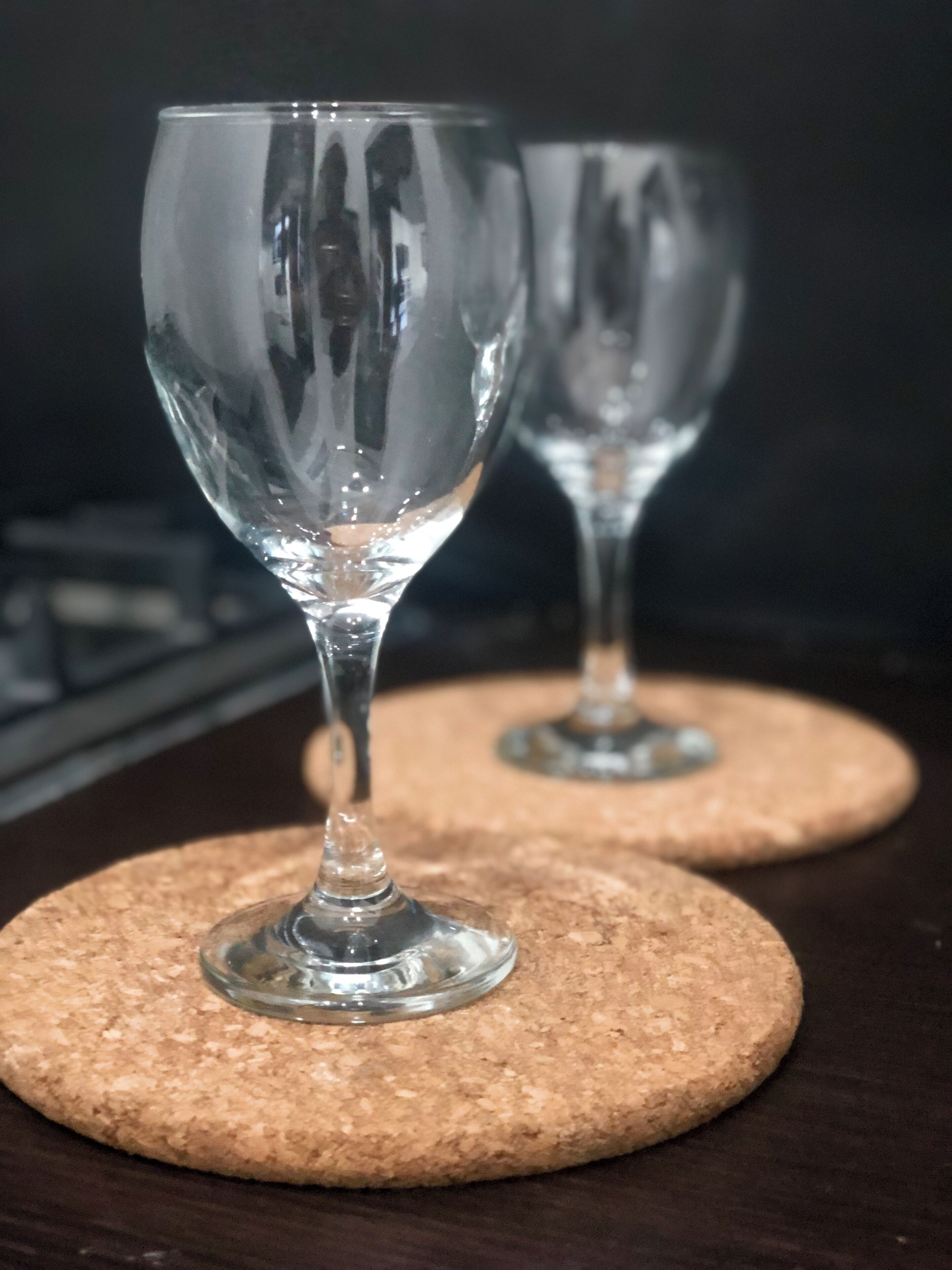 Two wine glasses on coasters.