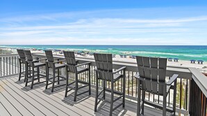 A deck with chairs overlooking a beach. - Green Reef #7- Emerald Horizon (Destin)