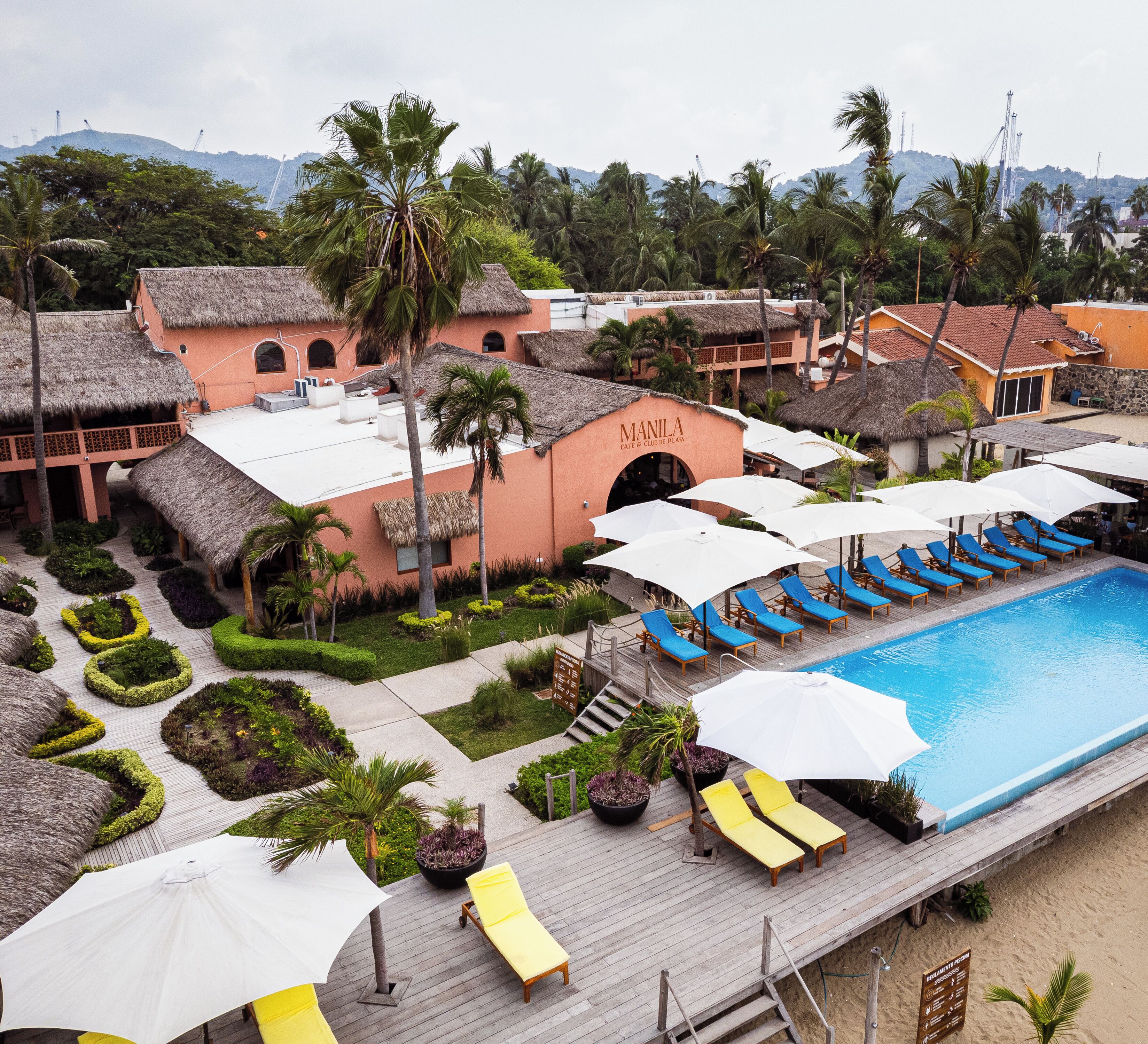 A resort with a swimming pool, lounge chairs, and a building labeled 'MANILA'.