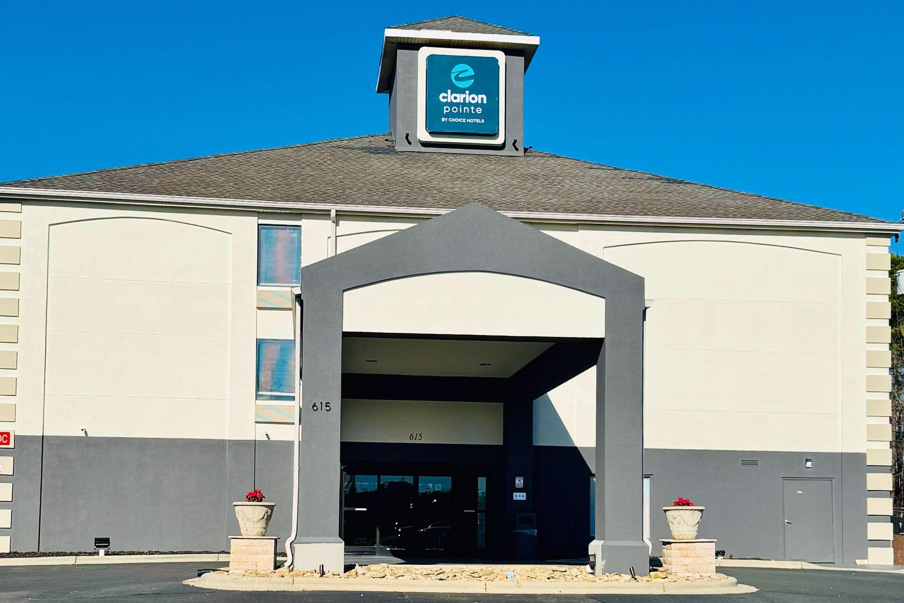 A hotel entrance with a clear sign reading "Clarion Pointe by Choice Hotels."