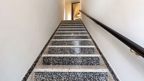 A staircase with a handrail and a light fixture at the top.