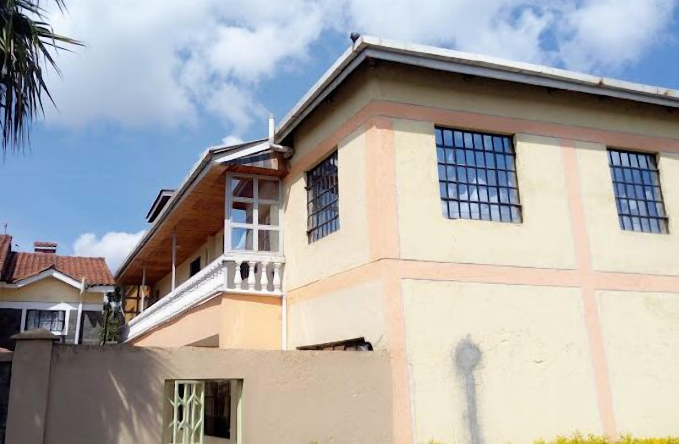 A two-story building with a balcony on the upper floor.
