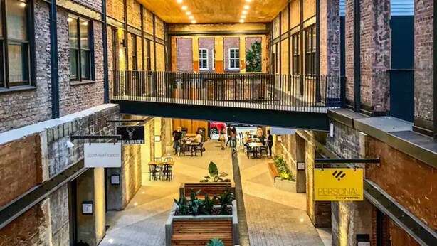 Un espace intérieur à plusieurs niveaux, doté d’un espace central ouvert, d’aménagements pour s’asseoir et d’un panneau indiquant « ESPACE PERSONNEL  ».