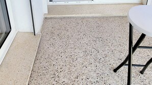 A modern kitchen with a large window, a dining area with a table and chairs, and a balcony with a view. - La Frégate Town Centre and Beach (Le Grau-du-Roi)