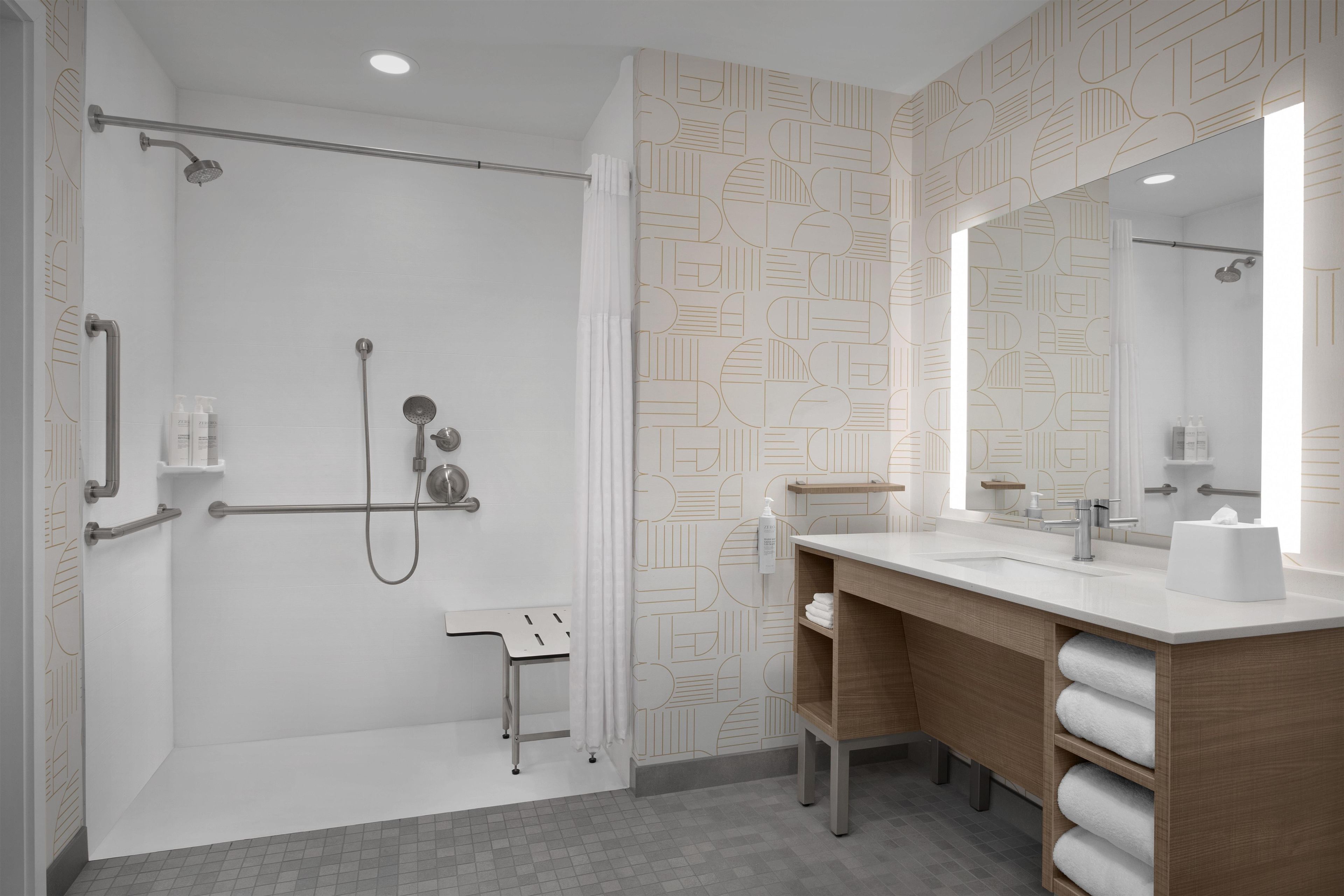 A modern bathroom with a shower, toilet, and vanity.