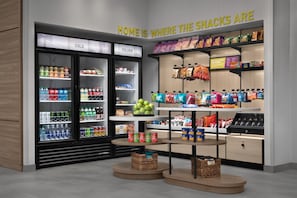 A snack display area with various packaged snacks and beverages. - Home2 Suites By Hilton Ashburn, Va (Ashburn)