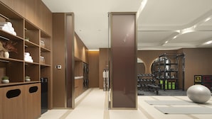 A modern gym with wooden lockers, exercise equipment, and a large exercise ball. - Hilton Garden Inn Zhongwei Shapotou (Zhongwei)