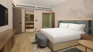A modern hotel room with a large bed, a desk, a bench, and a small table. - Hilton Garden Inn Zhongwei Shapotou (Zhongwei)
