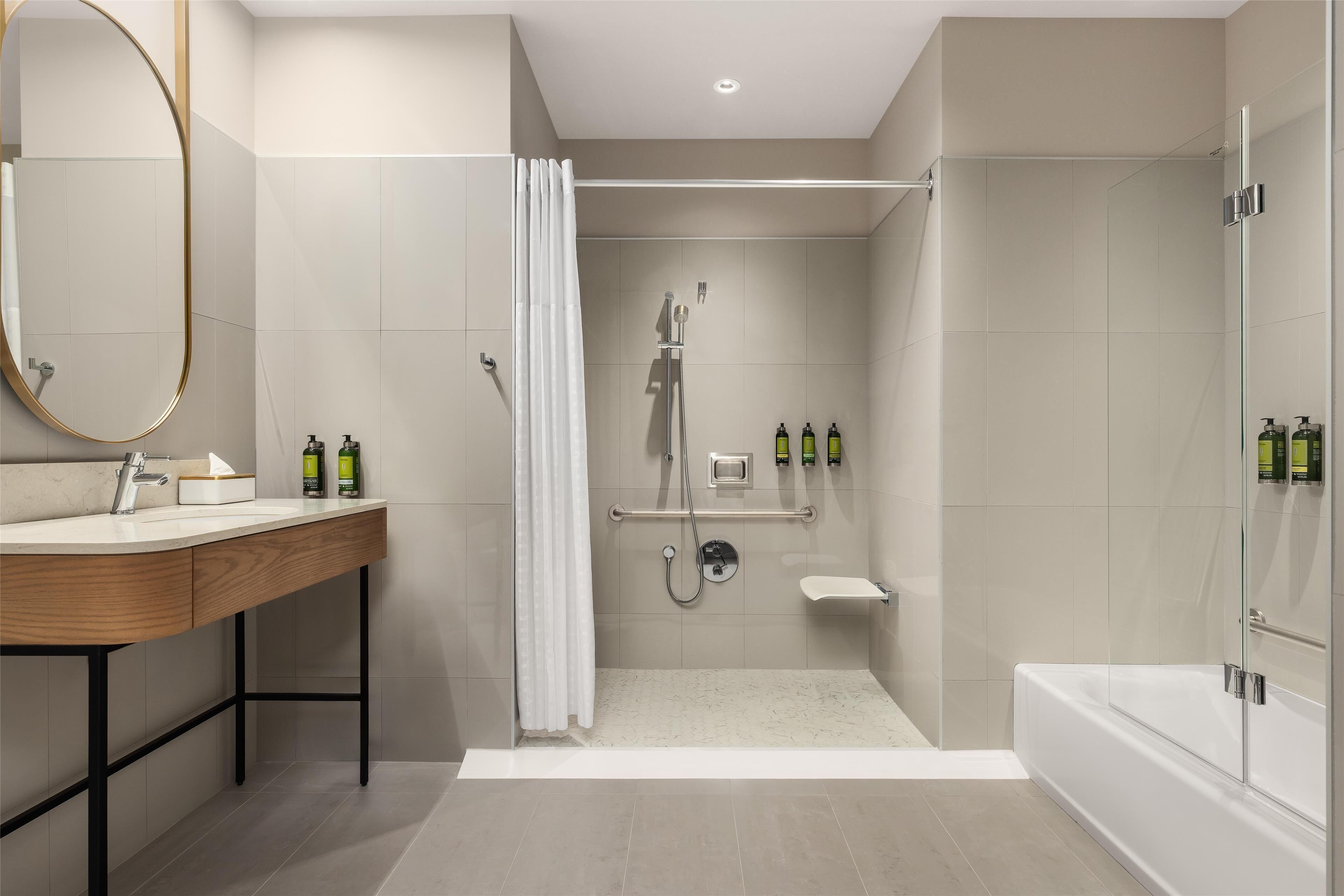A modern bathroom with a vanity, shower, and bathtub.