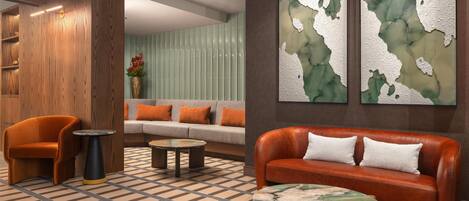A lobby with a wooden accent wall, a sofa, a leather couch, and a patterned floor.