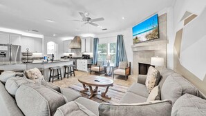 A modern living room with a sofa set, a coffee table, and a fireplace. - Saltaire (Santa Rosa Beach)