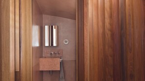 A modern bathroom with a wooden vanity, a mirror, and a towel rack. - Riley House, Surry Hills Isyd (Surry Hills)