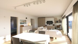 A modern living room with a dining area, a sofa set, and a TV mounted on the wall. - Apartment in Het Zoute With Sea Views (Knokke-Heist)