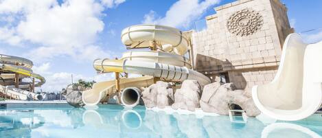 A water park with multiple slides and a pool.