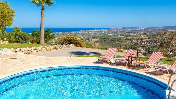 A swimming pool with lounge chairs, a palm tree, and a view of the coastline. - Villa Top Hill - Three Bedroom Villa, Sleeps 6 (Agia Triada)