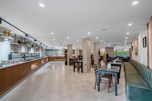 A modern dining area with a buffet, wooden counter, and seating arrangements. - Sun Heaven Queen (Alanya)