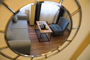 A room with a sofa, a chair, and a table with a tray. - La Vitinre (Istanbul)