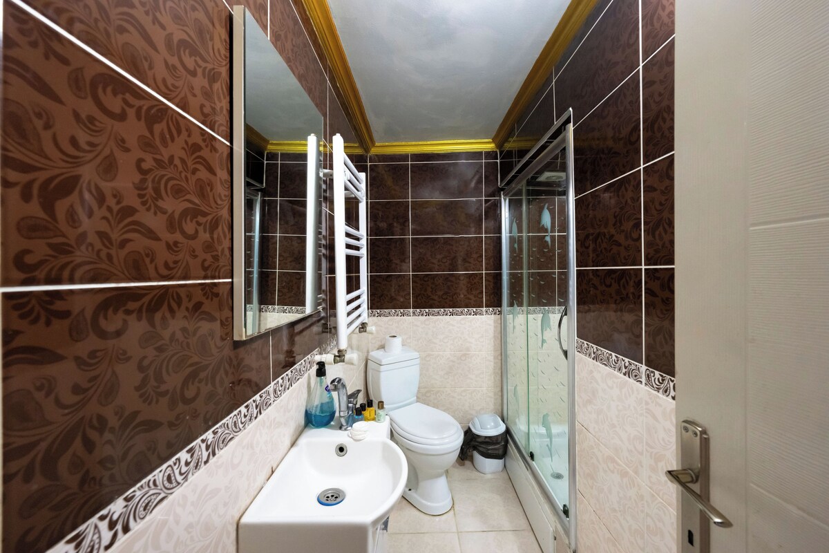 A bathroom with a sink, toilet, and shower.