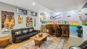 Ein gemütlicher Lounge-Bereich mit Ledersofa, Holztisch und Barhocker. Ein Wandgemälde zeigt den Schriftzug: "Cleveland is the reason.".