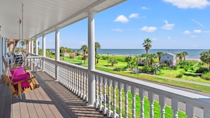 A wooden porch with a swing chair and a view of the beach and ocean. - Oceanfront Cor Bldg/Cor Unit 3BR, Loads of Windows & Ocean Views, Balcony, Pool (Myrtle Beach)