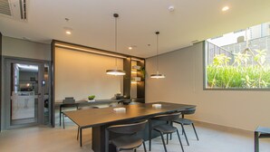 A modern kitchen with a large island, pendant lighting, and a view of greenery outside. - Cozy Near Allianz Parque Sp-p2402b (São Paulo)