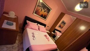 A bedroom with a bed, a nightstand, a mirror, and a door. - Charming 2-bedroom apartment with completed kitchen, nera Milano, Como and Swiss (Mozzate)