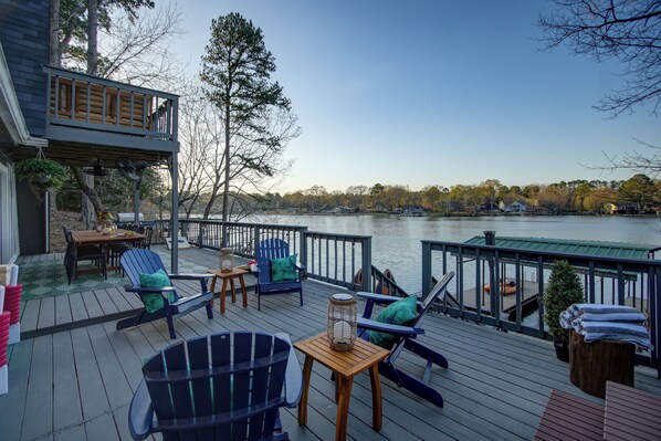 A deck with outdoor furniture, a table, and a lantern.