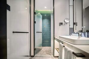 A modern bathroom with a glass shower enclosure, a white sink, and a mirror. - Holiday Inn Express Yibin Xuzhou by IHG (Yibin)