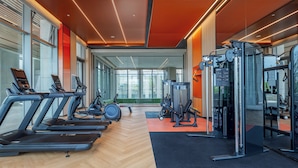 A modern gym with treadmills, weight machines, and a mirror wall. - EVEN Hotel Yining by IHG (Yining)