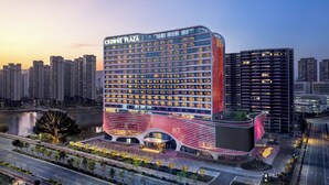 A modern hotel with a curved facade, multiple floors, and a prominent entrance area. - Crowne Plaza Putian by IHG (Putian)