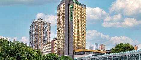 A tall hotel with a modern design, featuring a prominent 'Holiday Inn Express' sign.