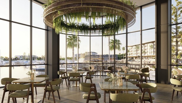 A modern indoor dining area with large windows, a circular hanging planter with greenery, and a view of a marina and buildings. - Crowne Plaza Shell Cove Marina by IHG (Shell Cove)