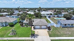 A residential area with houses, a driveway, and a lawn.