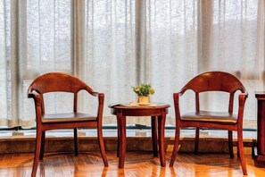 Cozy conversation area with two chairs and a small table, perfect for a quiet meeting or relaxing moment.