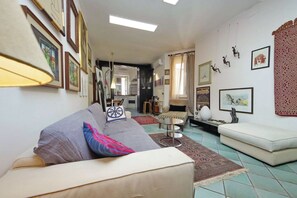 A living room with a sofa, a coffee table, and a patterned rug. - Rome, characteristic apartment for 5 close to the Vatican (Roma)