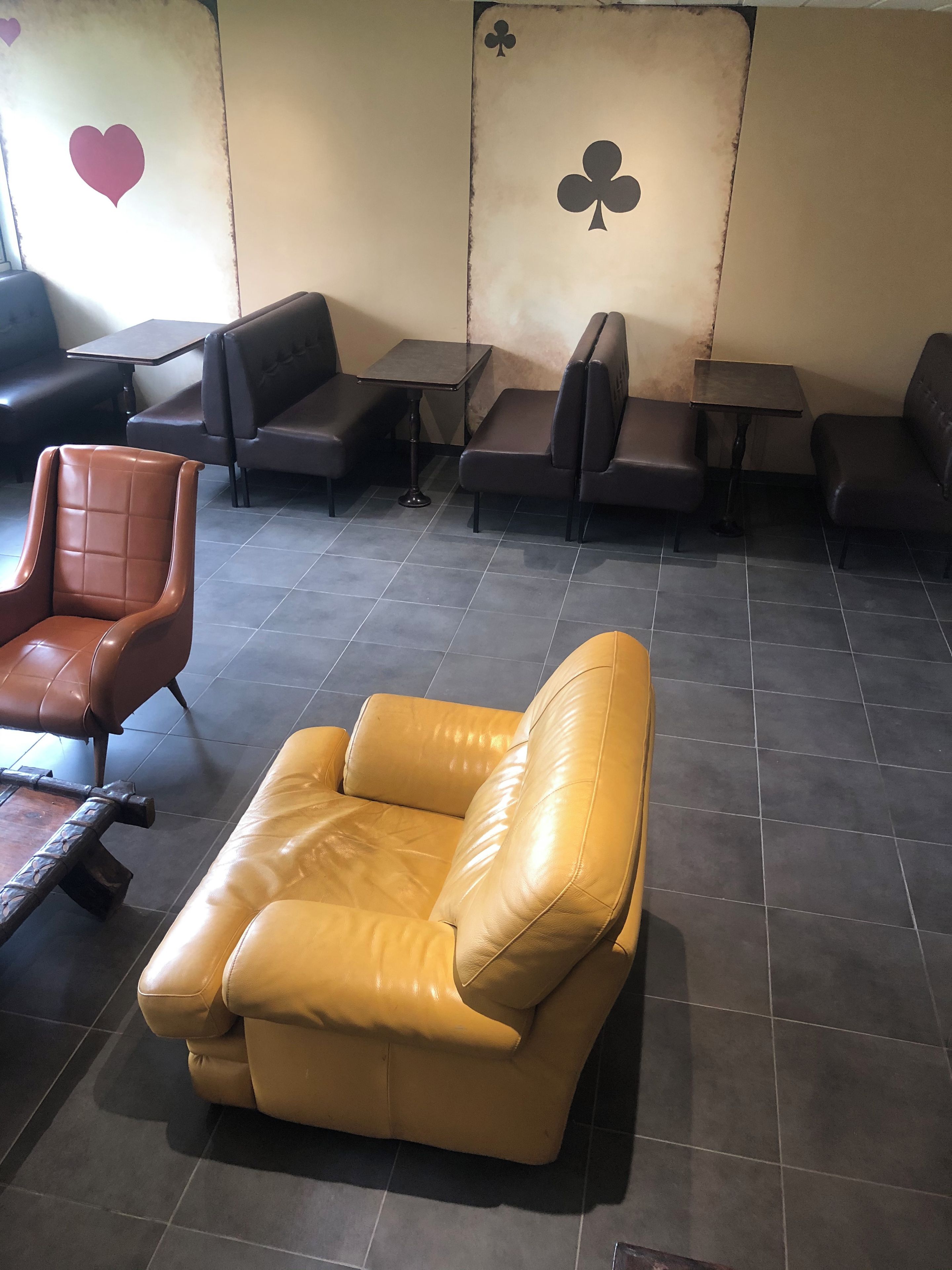 A seating area with leather sofas and tables, arranged in a casual layout.