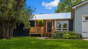 A house with a front porch, a small deck, and a garage.