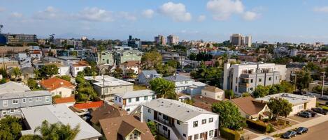 A residential area with houses, a parking lot, and a clear sky.