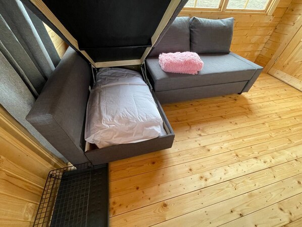 A compact room with two gray sofas, one with a white pillow and the other with a pink fluffy pillow. - Cozy Cottage on Hillside with Breathtaking Mountain Views, 3 mins from Route 1 (Hvammstangi)