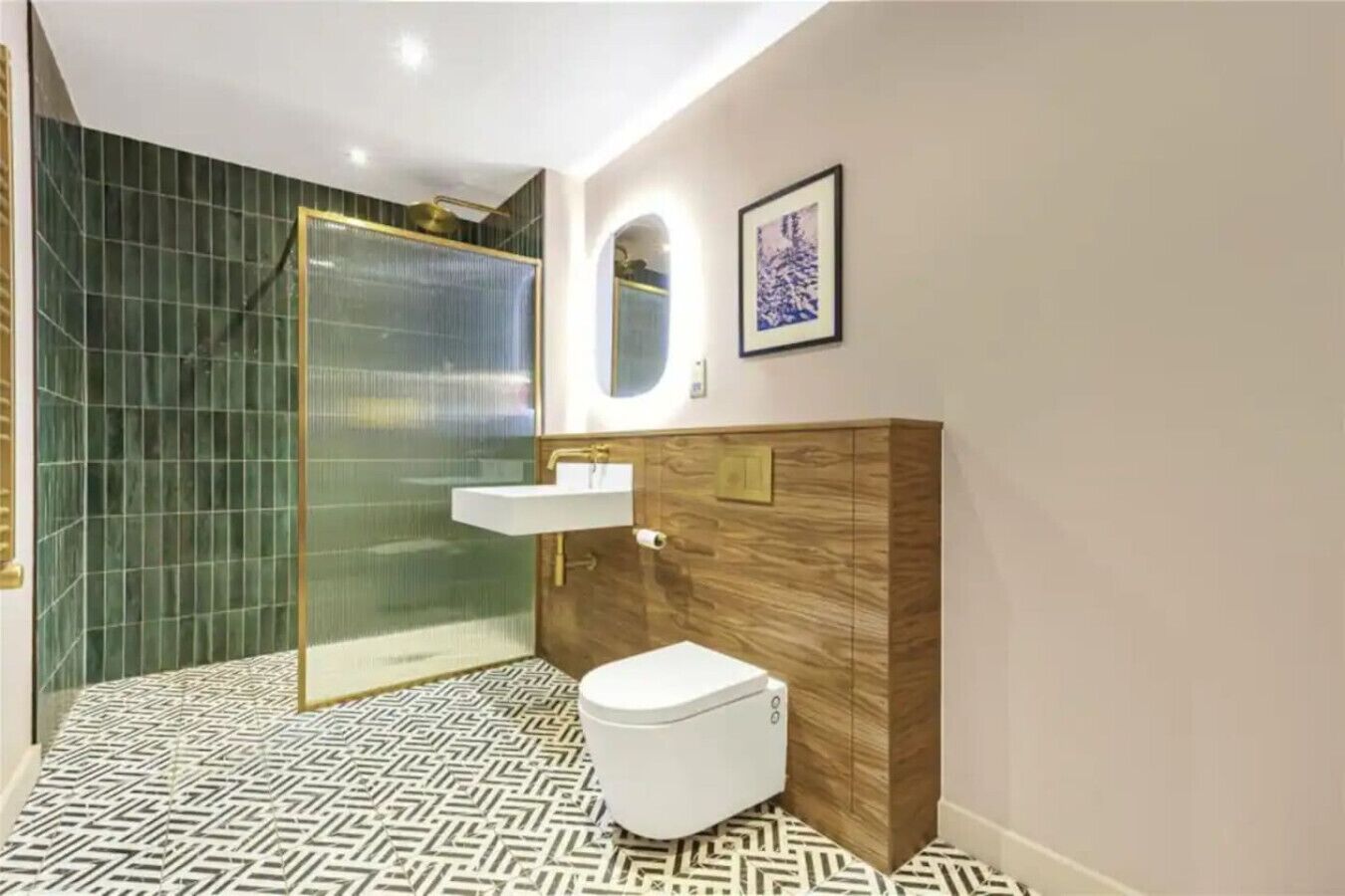 A modern bathroom with a glass shower enclosure, a white toilet, and a wooden vanity with a sink.