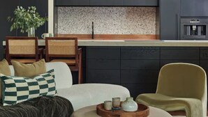 A modern living room with a sofa, armchairs, and a coffee table.