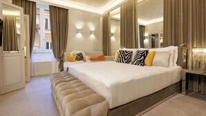 A spacious bedroom with a large bed, a bench, and a mirror. - Luxurious 3 Bedroom Apartment near Pantheon (Roma)