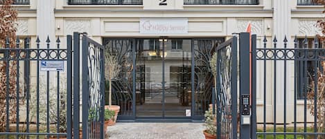 A building entrance with a sign reading "Happy Senior" and a number "2" above the door.