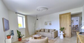 Relax in this stylish living room with a comfortable sofa, armchair, and coffee table.