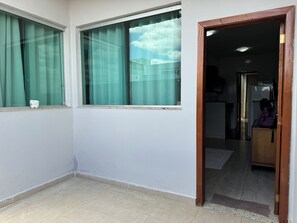 Enjoy a view of the city from this corner room with a window and sheer curtains.